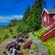 A group of people at Steinsfjellet viewpoint seated around picnic tables